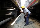 On the Job at Union Station - Honorable Mention  TCU Carman John Myers inspects wheels and brakes on an Amtrak train.  Photographer: David Gifford, TCU Local 1908.