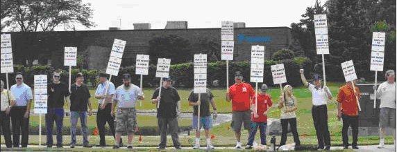 Striking members of Local 2159 picket on the road to U.S. Tsubaki in Wheeling, IL