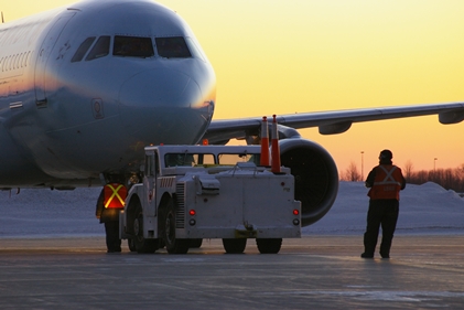 By planning legislation to allow foreign companies to own up to 49 percent of an airline in Canada, the Canadian government is risking thousands of IAM jobs, and those of other transport workers. (Air Canada jet pushback)